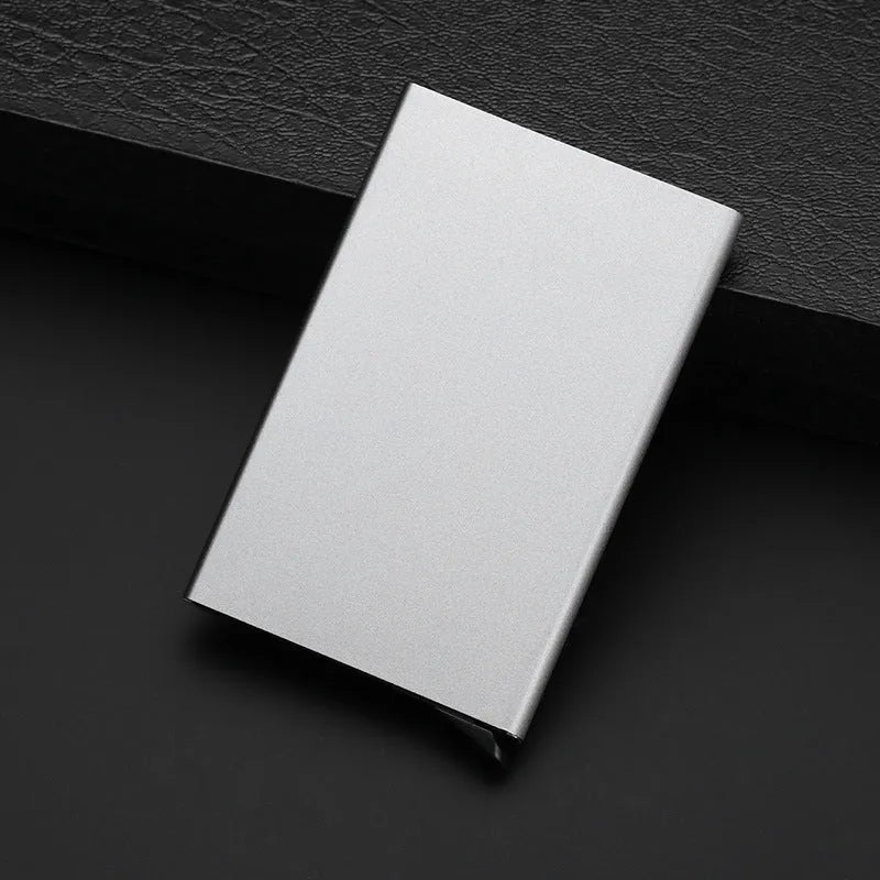 Geometric aluminium business card holder in gold finish displaying business cards