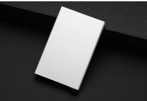 Geometric aluminium business card holder in gold finish displaying business cards