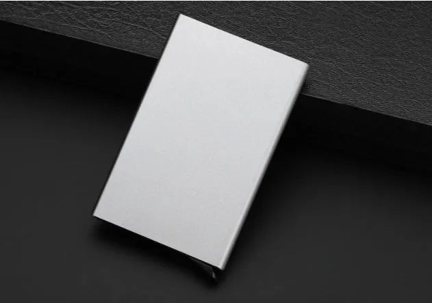 Geometric aluminium business card holder in gold finish displaying business cards