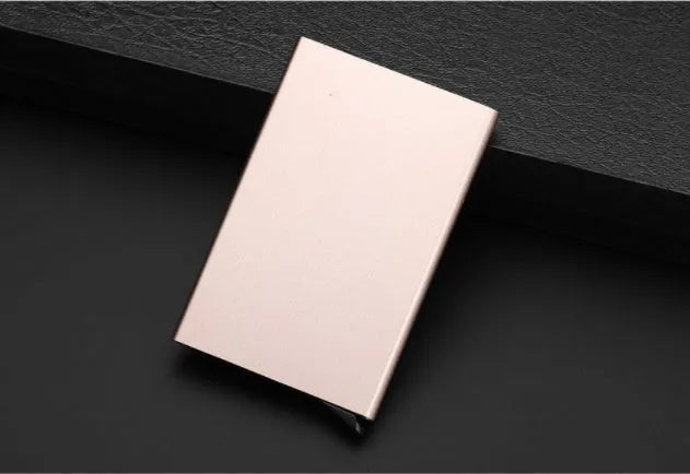 Geometric aluminium business card holder in gold finish displaying business cards