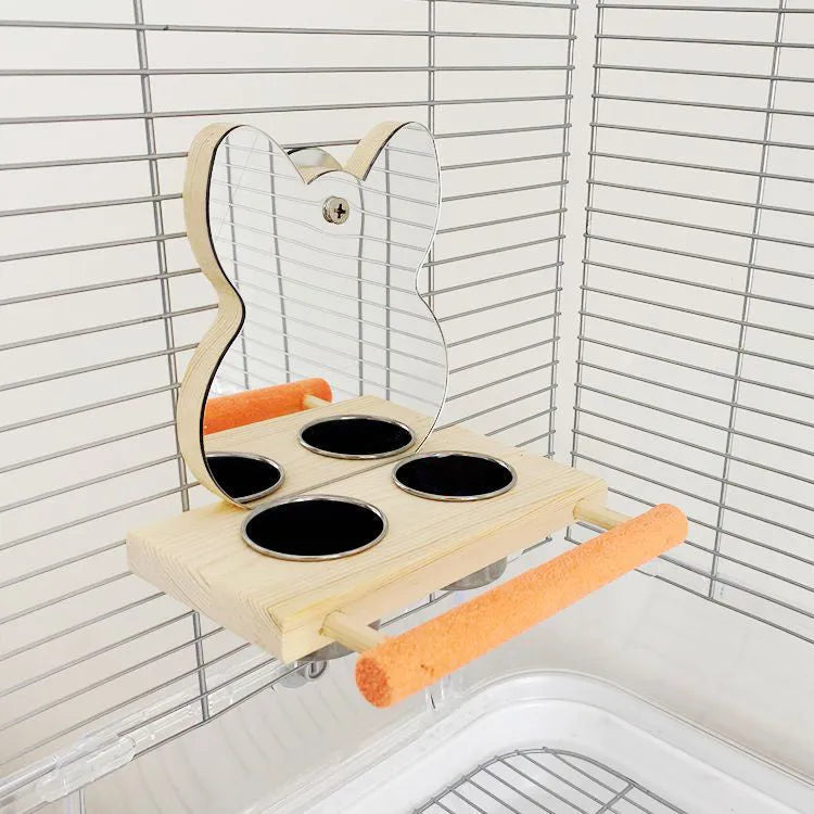 Wood-coloured parrot toy with stainless steel food cup, mirror, and grinding claw perch on a compact stand
