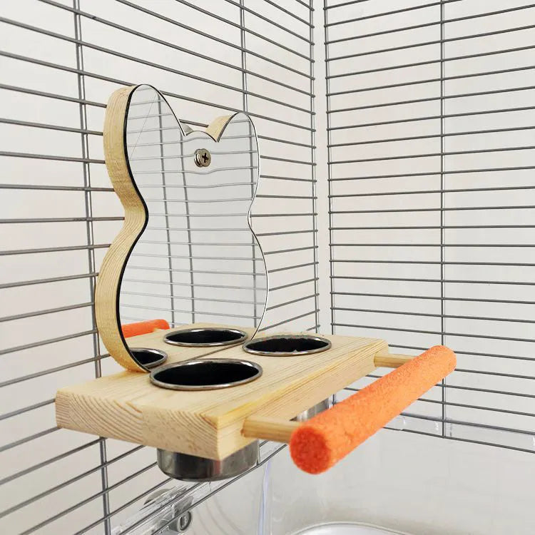 Wood-coloured parrot toy with stainless steel food cup, mirror, and grinding claw perch on a compact stand