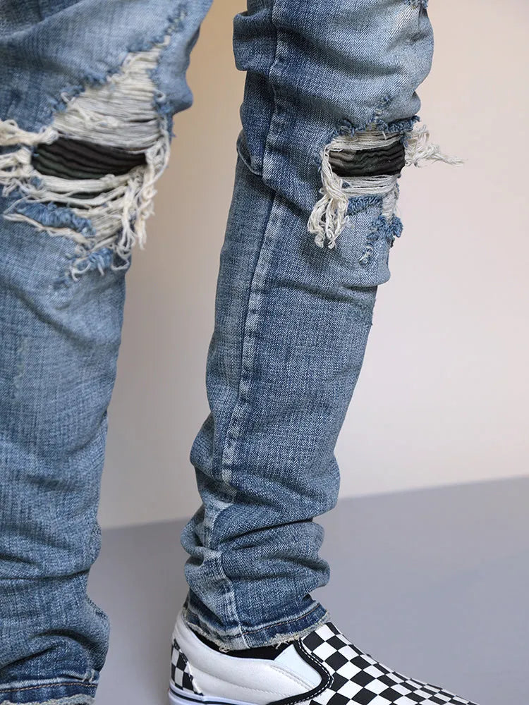 Men's ripped washed blue cotton denim jeans with mid waist and zip fly, sizes M to XXL