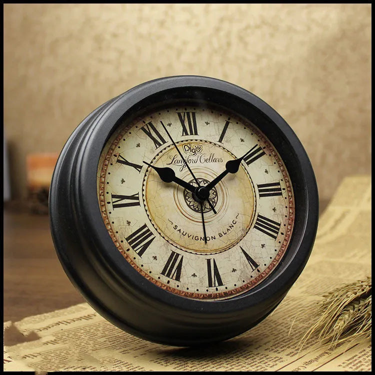 Round retro European-style 6-inch desk alarm clock with a white dial on a wooden surface.