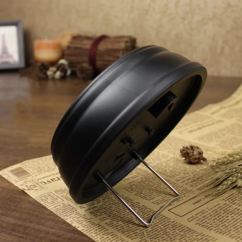 Round retro European-style 6-inch desk alarm clock with a white dial on a wooden surface.
