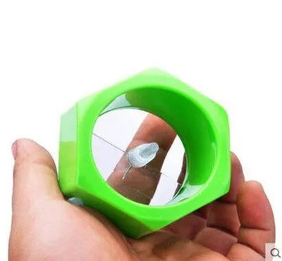 Yellow and green spiral knife vegetable cutter made of plastic on a kitchen worktop.