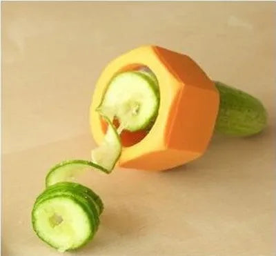 Yellow and green spiral knife vegetable cutter made of plastic on a kitchen worktop.