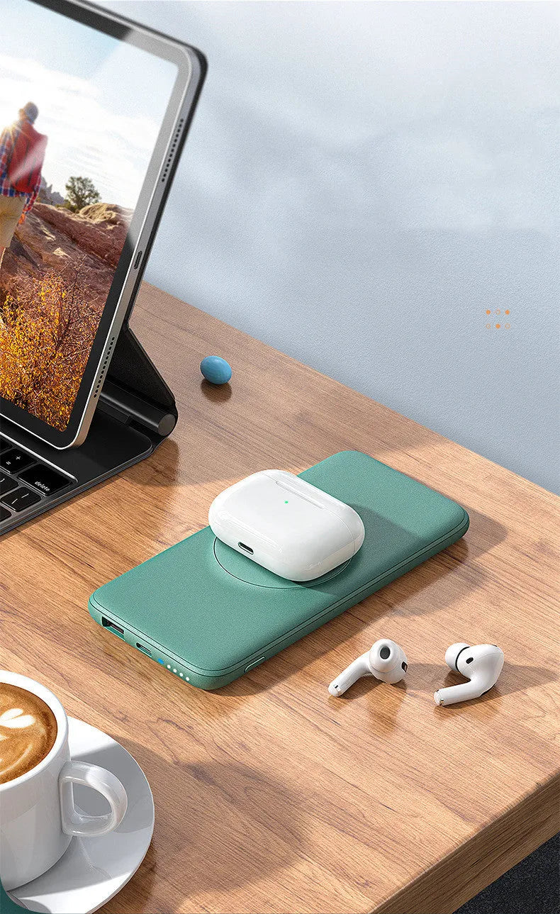 Maiduo mint green Magsafe power bank magnetically attached to an iPhone, showing its slim clip-on design.