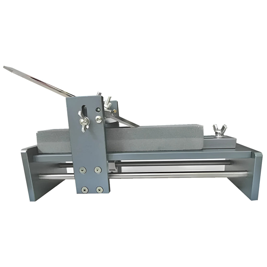 Aluminium fixed angle sharpening tool for woodworking chisels and planer blades on a workbench.