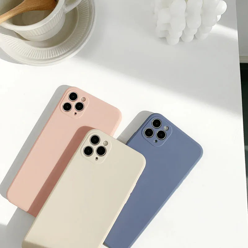 Simple solid colour silicone iPhone case in powder blue on a table.