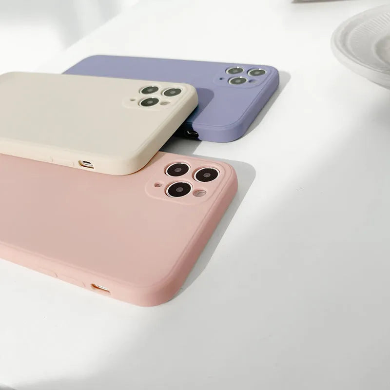 Simple solid colour silicone iPhone case in powder blue on a table.