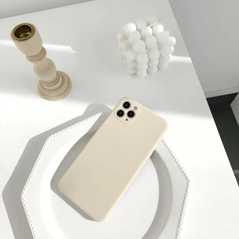 Simple solid colour silicone iPhone case in powder blue on a table.
