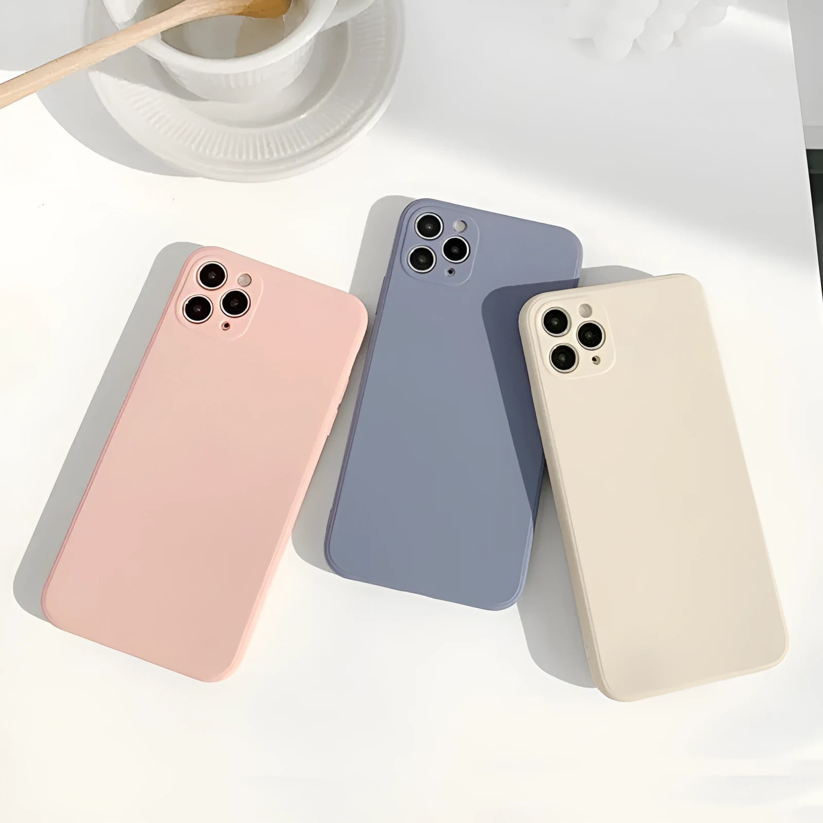 Simple solid colour silicone iPhone case in powder blue on a table.