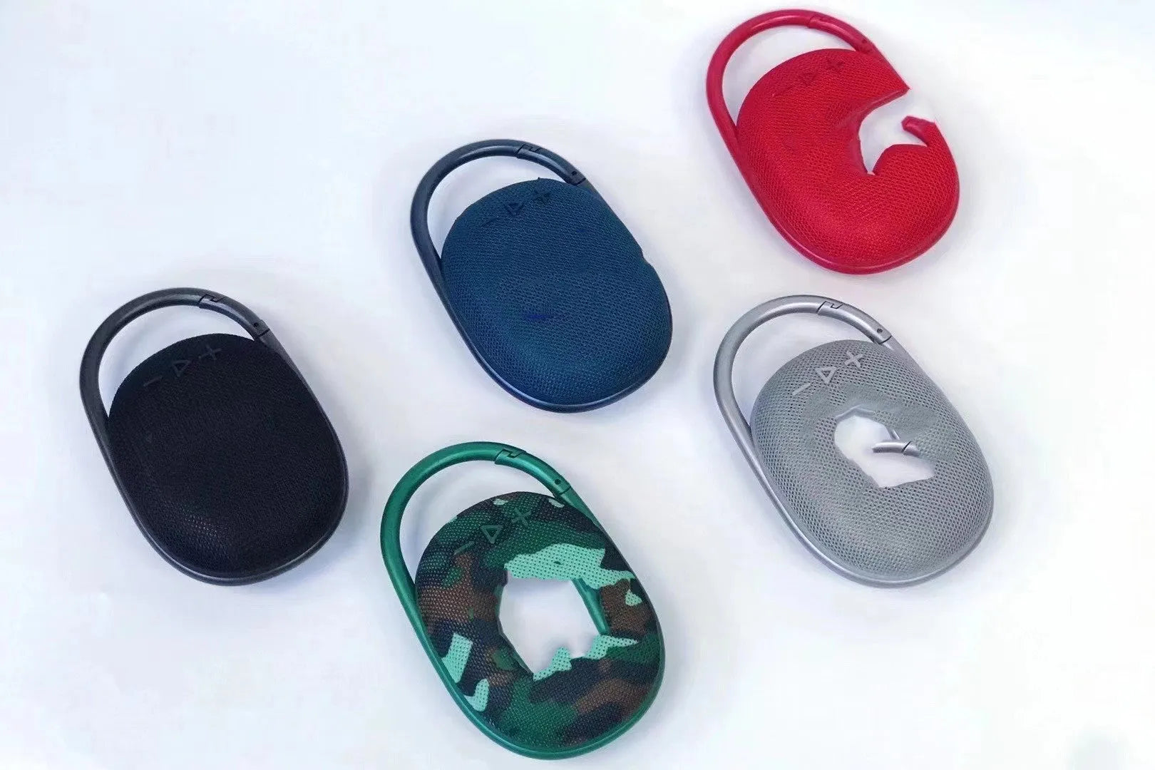 Mini portable Bluetooth wireless speaker in silver grey colour with USB cable.