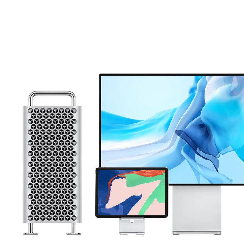 Dark space grey aluminium alloy mobile phone holder with adjustable clamp on a desk edge, holding a large tablet.