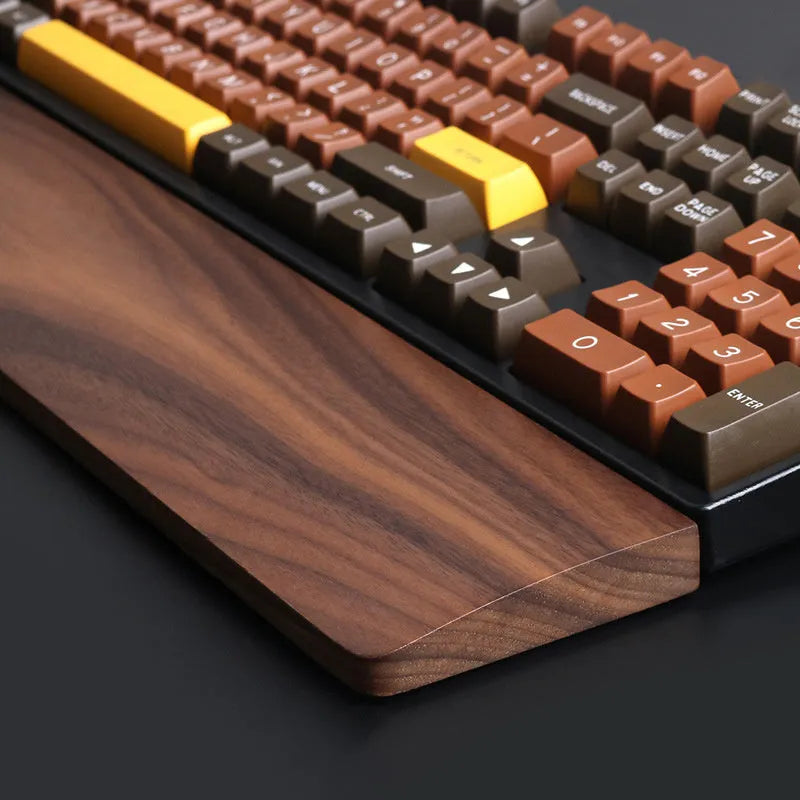 Walnut wood mechanical keyboard wrist rest showing natural wood grain and ergonomic design