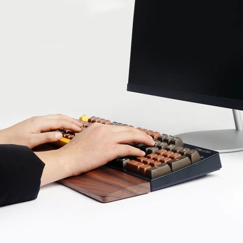 Walnut wood mechanical keyboard wrist rest showing natural wood grain and ergonomic design