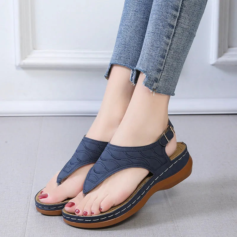 Women's wedge heel casual sandals in red with an adjustable back strap and flip-flop style.