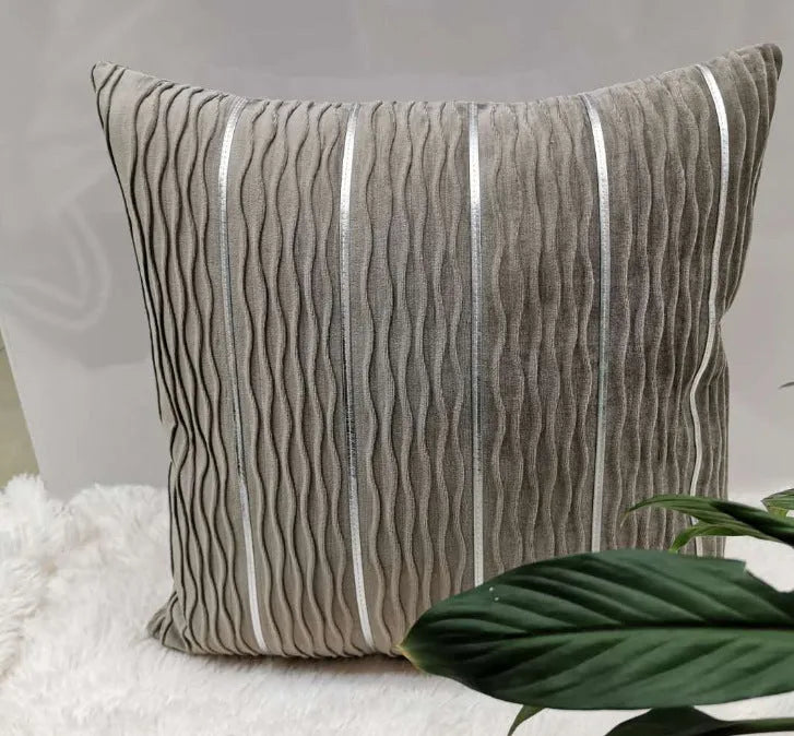 Soft striped velvet pillow cover for a sofa cushion in silver grey colour, shown on a chair.