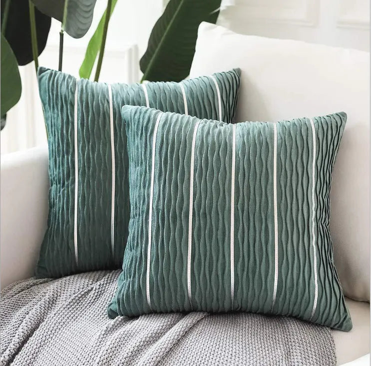 Soft striped velvet pillow cover for a sofa cushion in silver grey colour, shown on a chair.