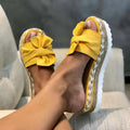 Platform wedge heel ladies bow sandals in cloth upper and imitation leather lining, shown in multiple colours.
