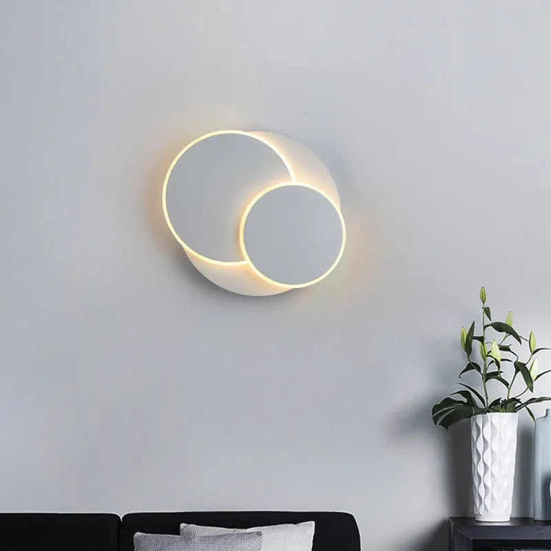 Modern round acrylic wall lamp in black or white, shown in small, middle, and large sizes for bedroom or living room.