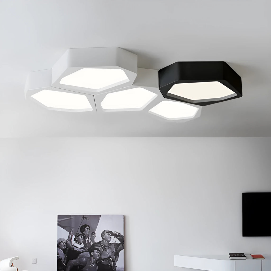 Modern geometric-shaped LED light with black iron frame and remote control on a side table.