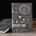 European relief embossed design on a metallic leather notepad cover, shown in green bronze, with dimensions 21.5 by 14.5 cm.