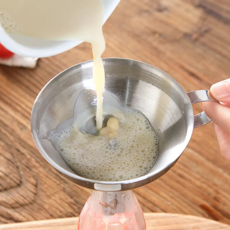 Small 201 stainless steel mini funnel with incorporated fine sieve, hanging on a hook, showing tube and bowl