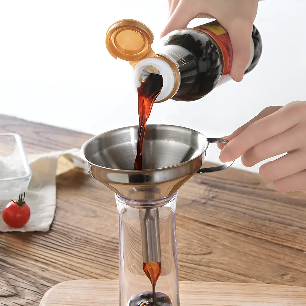 Small 201 stainless steel mini funnel with incorporated fine sieve, hanging on a hook, showing tube and bowl