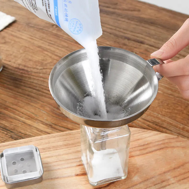 Small 201 stainless steel mini funnel with incorporated fine sieve, hanging on a hook, showing tube and bowl