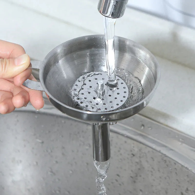 Small 201 stainless steel mini funnel with incorporated fine sieve, hanging on a hook, showing tube and bowl