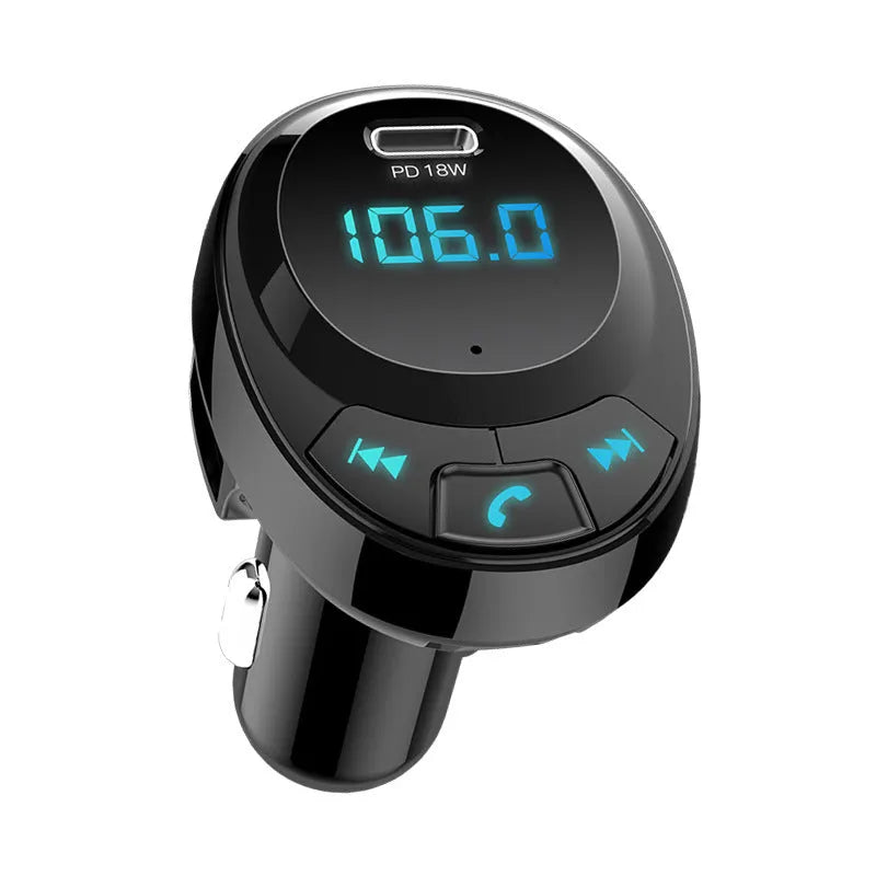 Compact black car Bluetooth MP3 player and dual USB charger with digital monochrome screen.