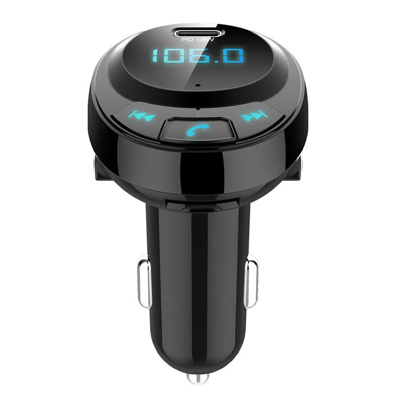 Compact black car Bluetooth MP3 player and dual USB charger with digital monochrome screen.