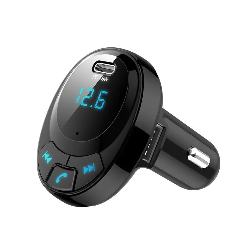 Compact black car Bluetooth MP3 player and dual USB charger with digital monochrome screen.