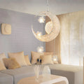 Zinc alloy chandelier with aluminium wire shade hanging from a ceiling, showing height adjustment.