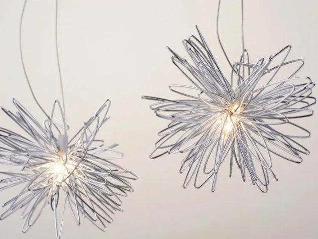 Zinc alloy chandelier with aluminium wire shade hanging from a ceiling, showing height adjustment.