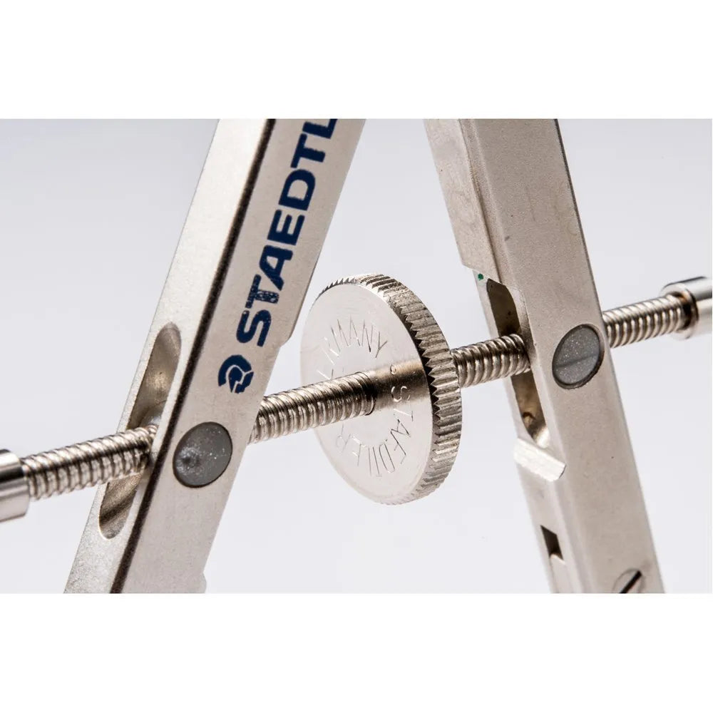 Staedtler 551 01 steel technical compass with telescopic centre rod and 12V car plug on a blueprint.