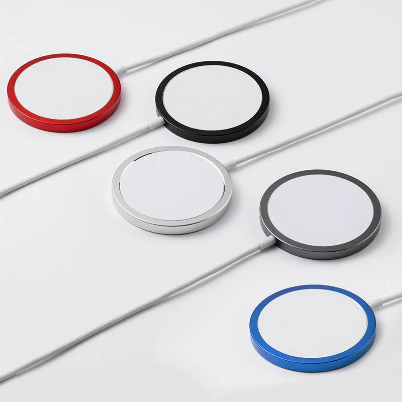 Silver metal Magsafe-compatible magnetic wireless charger for iPhone, shown next to a mobile phone.