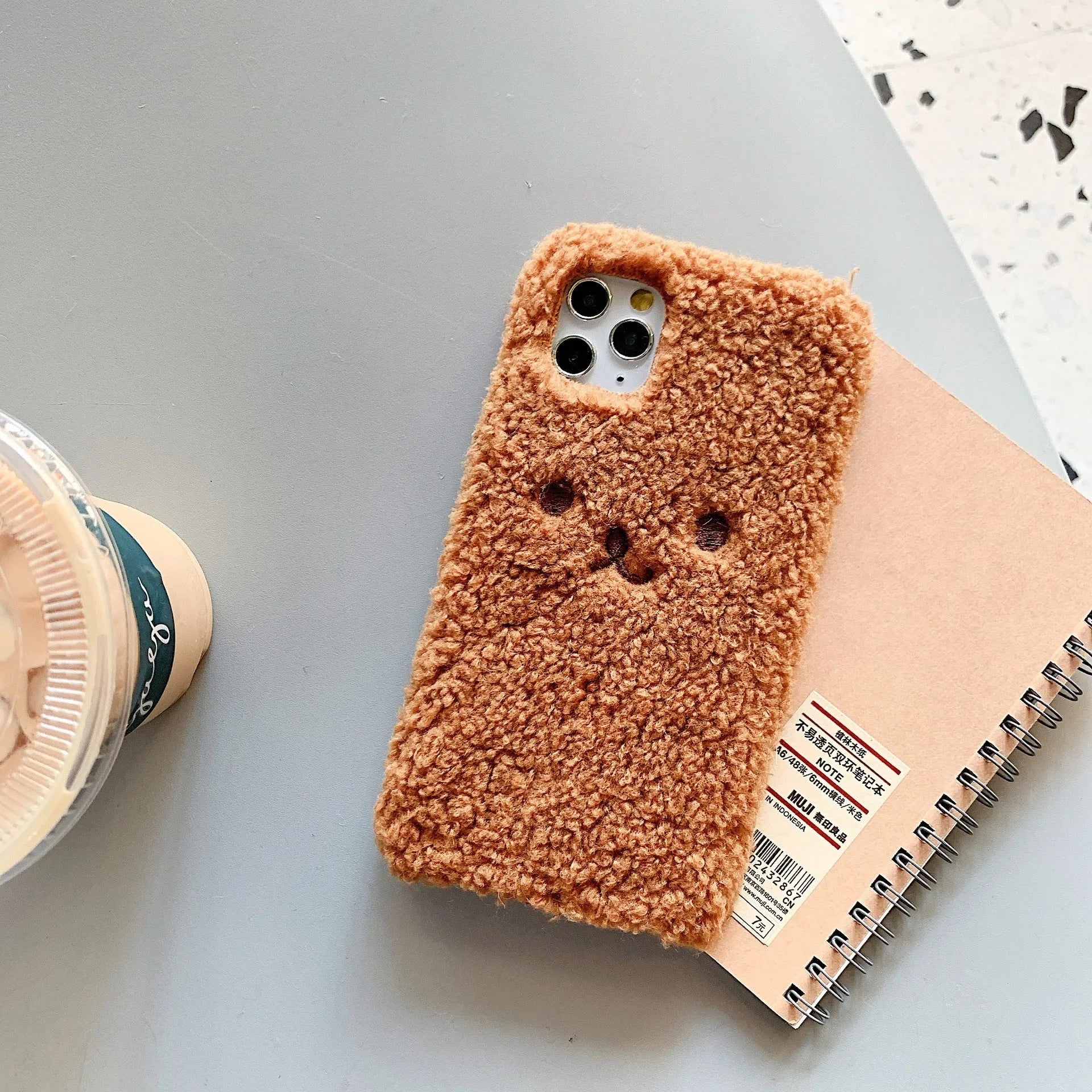 Brown embroidered plush bear face on a clear TPU iPhone case for iPhone 11