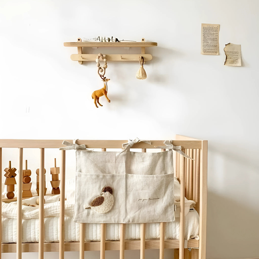 Khaki coloured cotton linen hanging storage bag with one large pocket beside a bed.