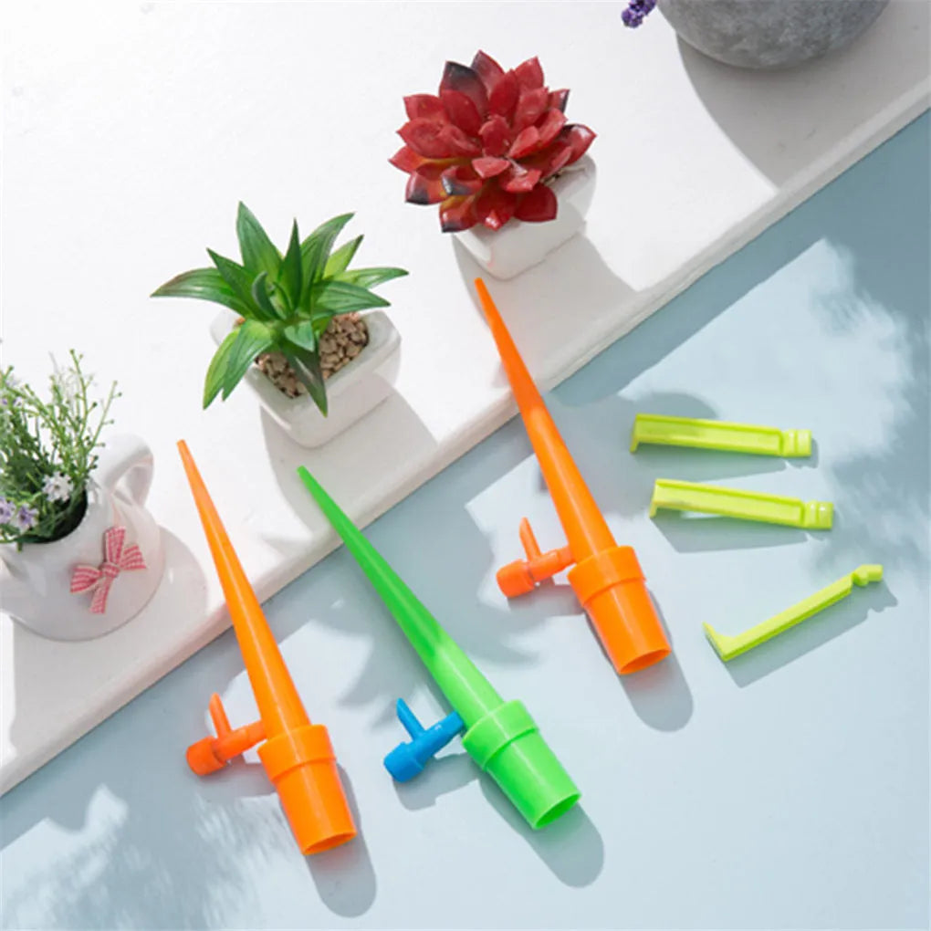 Ten plastic watering spikes 16.5cm long in green and orange for bottle-based garden irrigation