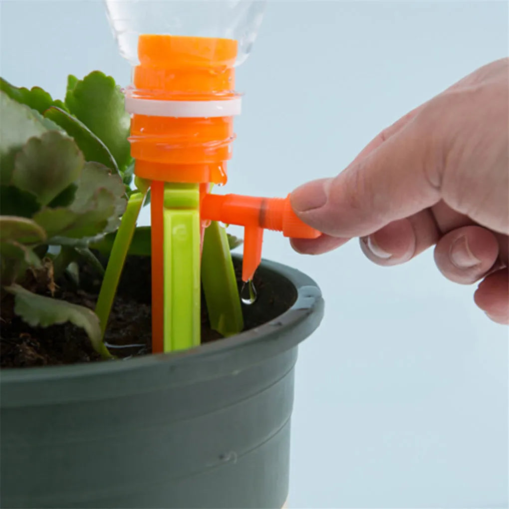 Ten plastic watering spikes 16.5cm long in green and orange for bottle-based garden irrigation