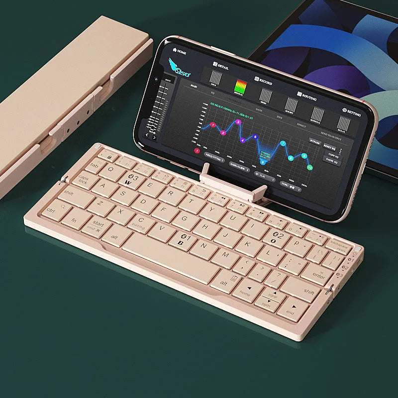 Silver white folding Bluetooth keyboard with stand holding smartphone