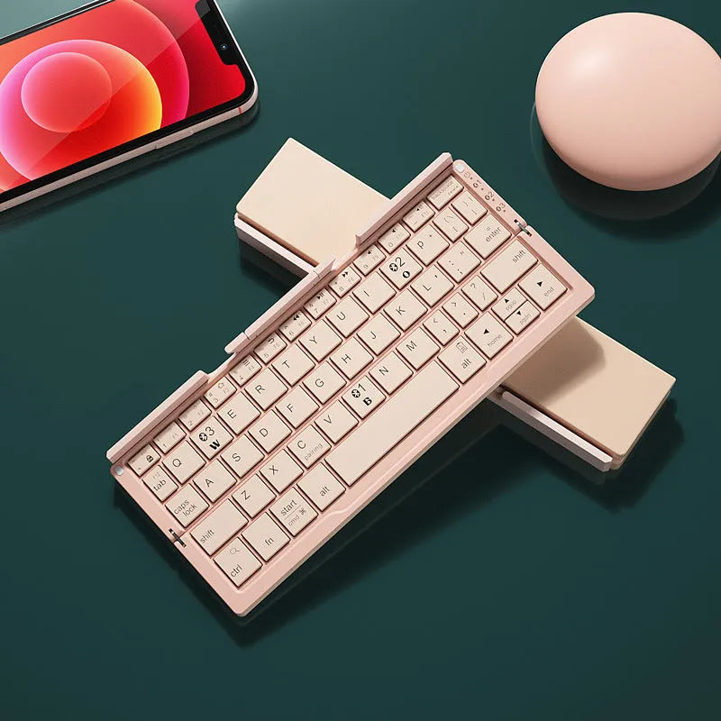 Silver white folding Bluetooth keyboard with stand holding smartphone
