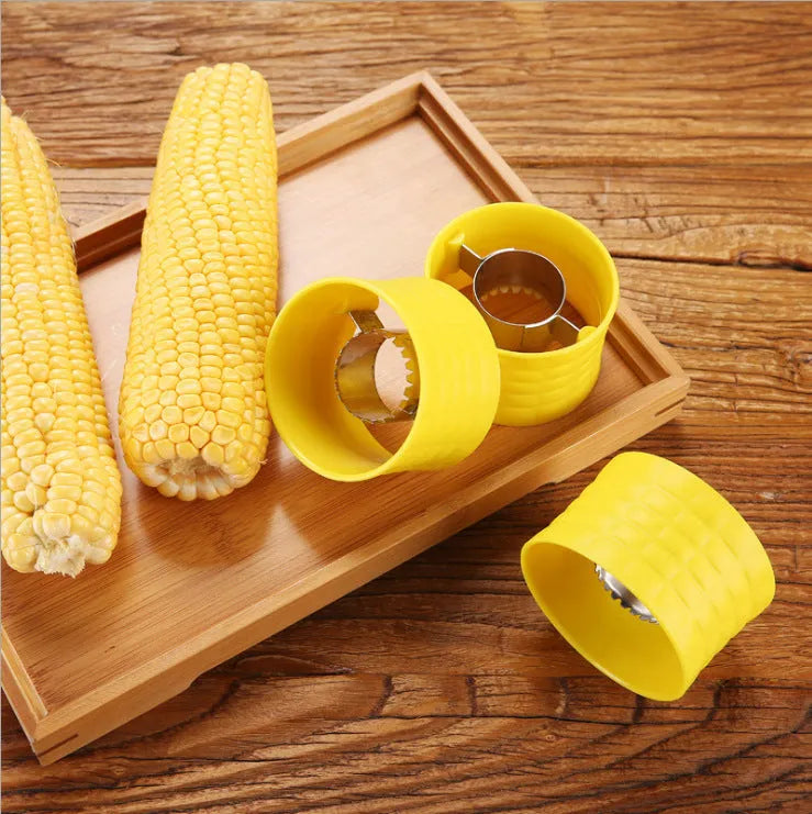 Yellow manual corn grinder thresher with corn-shaped design on a kitchen counter.