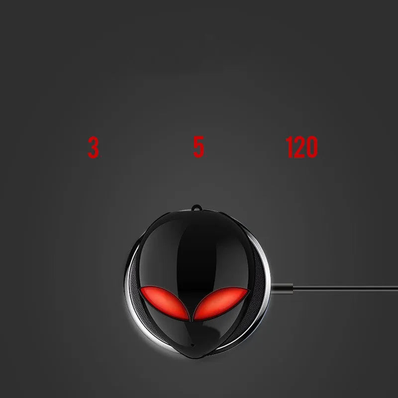 Creative Outer T8 Starman alien-shaped Bluetooth earbuds with LED lights next to their wireless charging case.