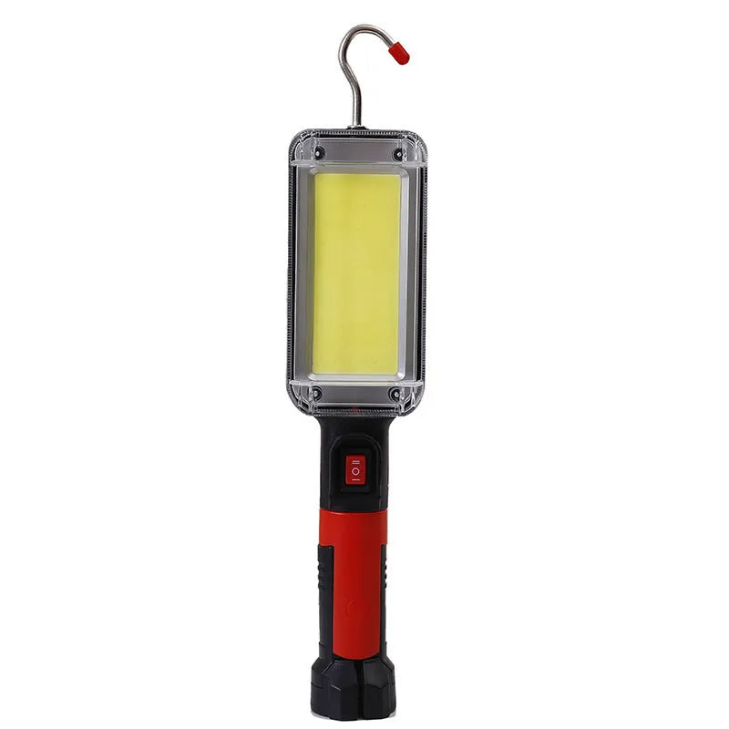 Red portable COB LED work light with magnet base and hook, showing USB charging port.