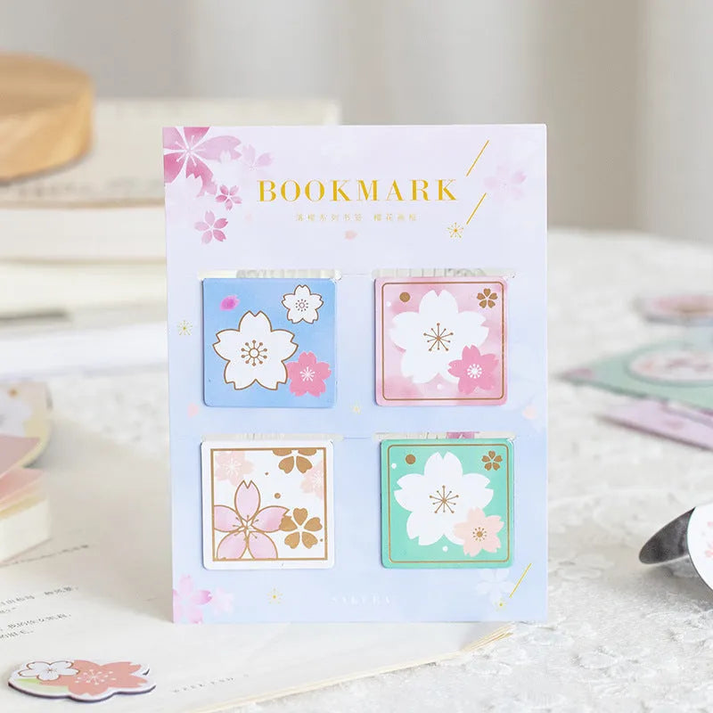 Set of four Yanji magnetic bookmarks with different cherry blossom designs on stone paper.