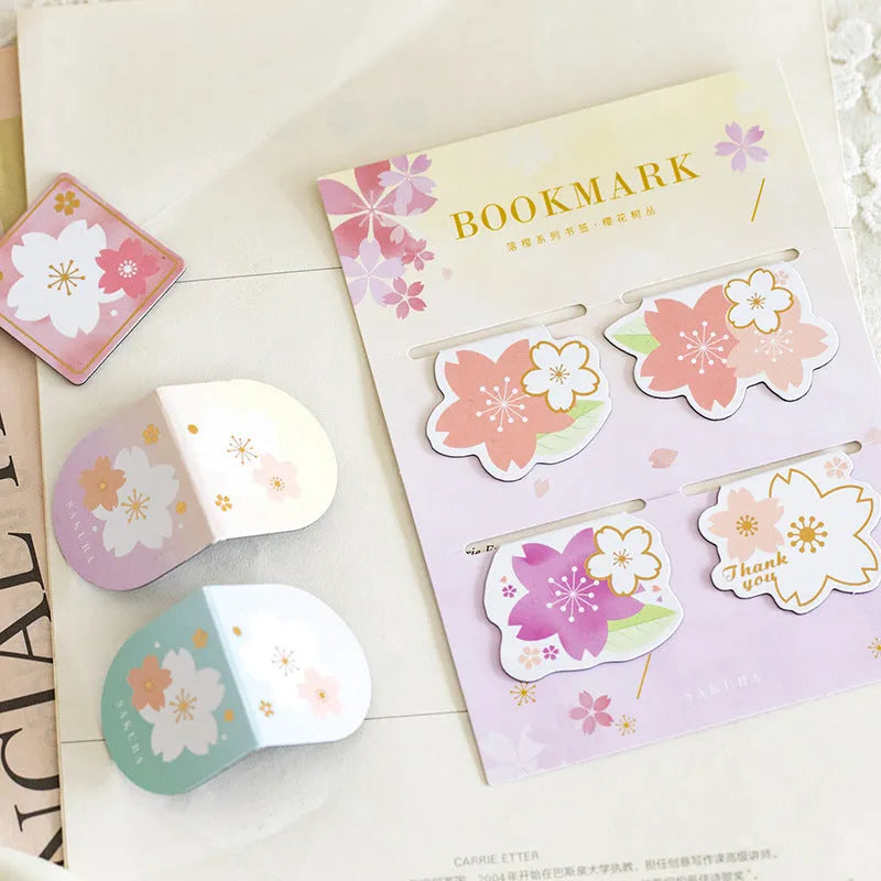 Set of four Yanji magnetic bookmarks with different cherry blossom designs on stone paper.